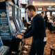 Player examines slot info on casino floor