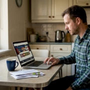 Person researching UK casino site at kitchen table
