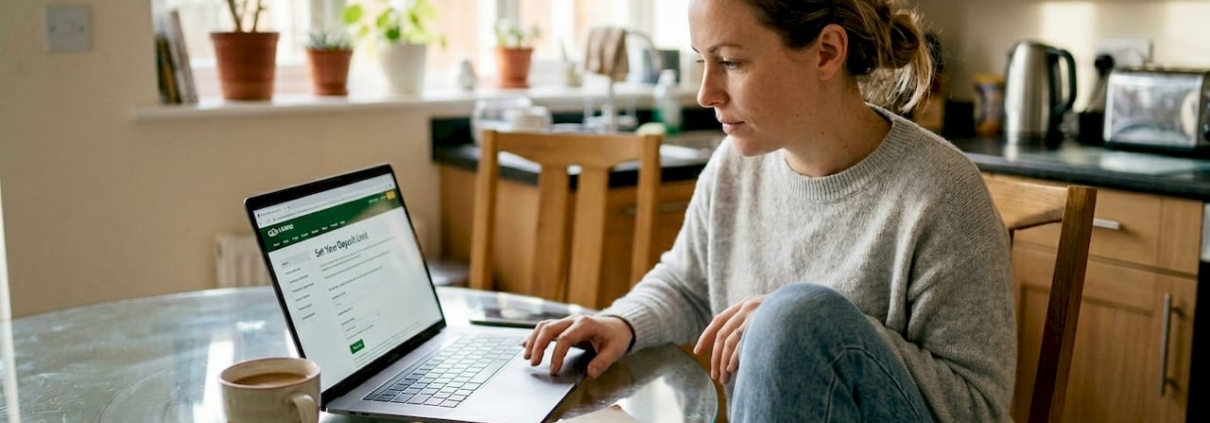 Woman viewing gambling limits page at home