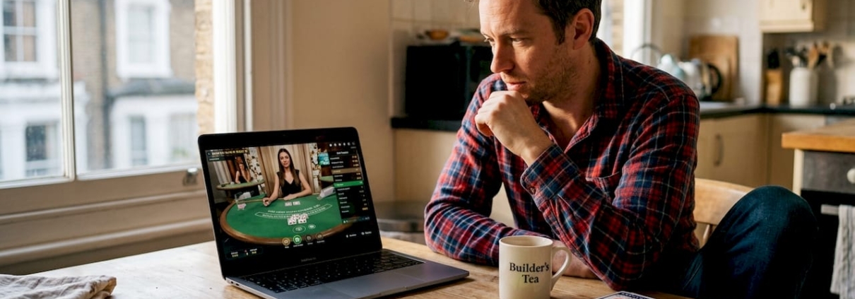 Man plays live dealer casino game at home