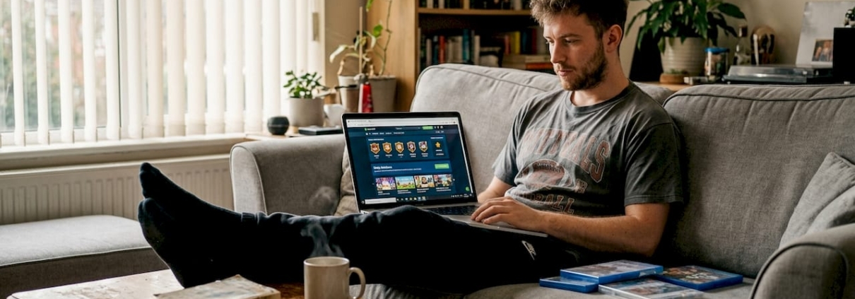 Man playing gamified casino site at home