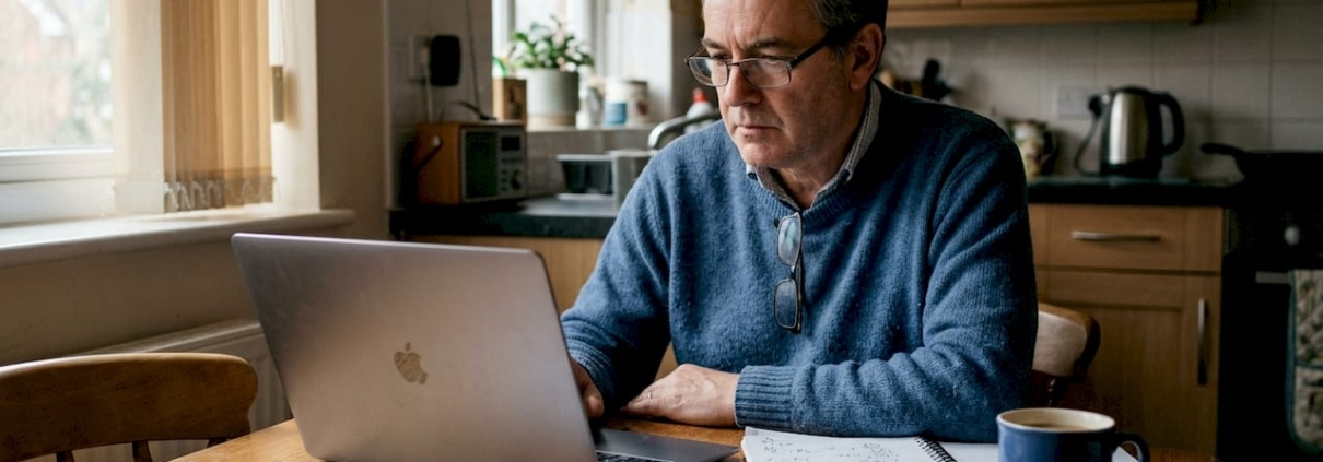 Man checking casino bonus details at home table