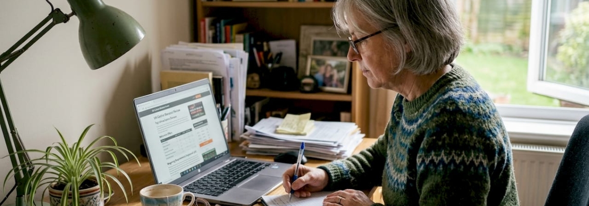 Woman researching casino bonus limits at desk