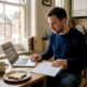 Man reading casino terms at kitchen table