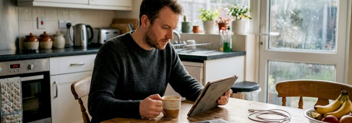 Man checks casino rewards on kitchen tablet