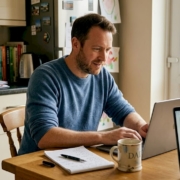 Man comparing casino offers on kitchen laptop