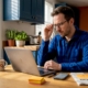 Man checking casino balance at kitchen table