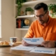 Man reviewing casino bonus terms at kitchen table