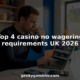 Man comparing casino sites on laptop at kitchen bar